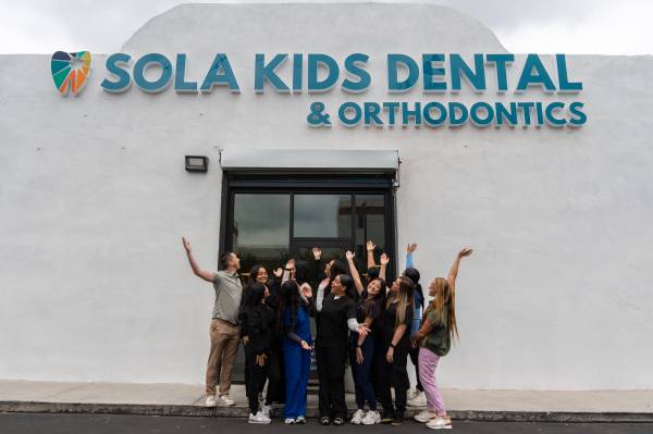 Sola Team in front of central office pointing up (2)